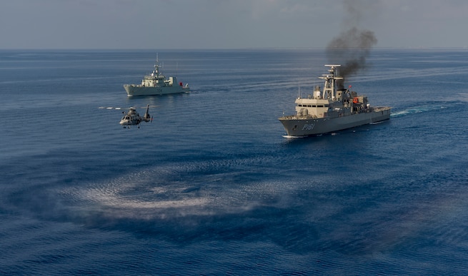 Ships sail in formation in the Atlantic Ocean.