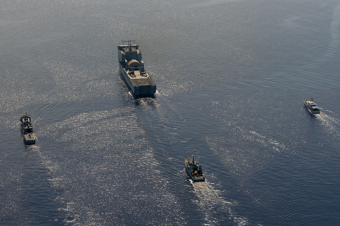 Ships sail in formation in the Atlantic Ocean.