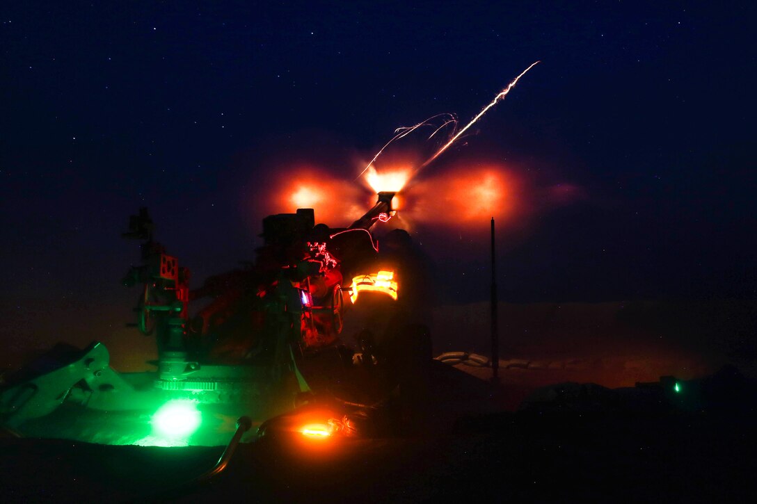 U.S. soldiers and Iraqi Security Force fire a howitzer.
