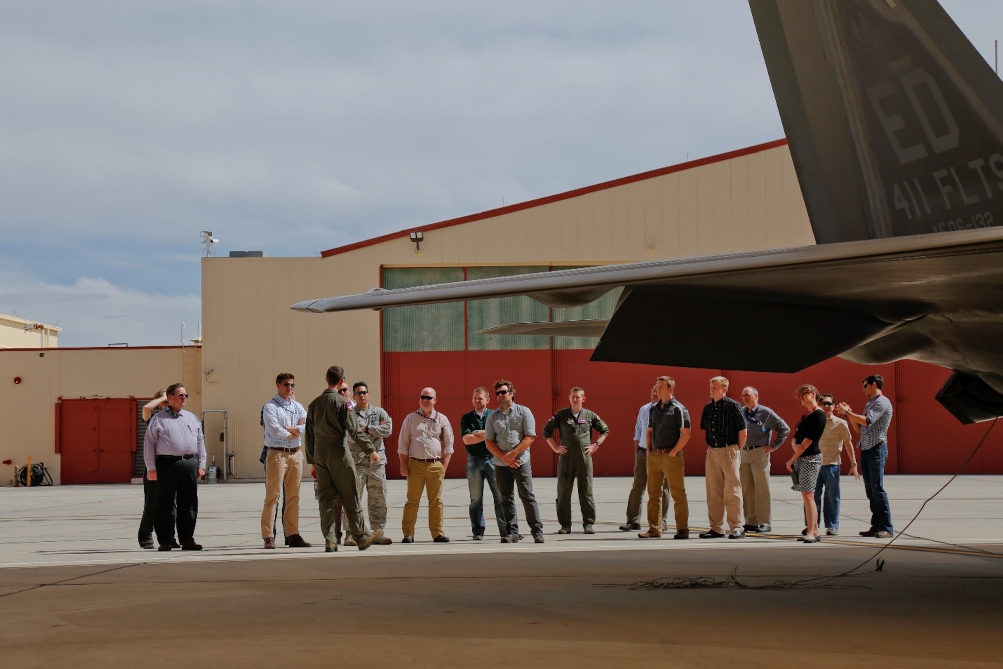 Members of the AEDC Junior Force Council get a lesson in the F-22 Raptor during a tour from Civilian Test Pilot Chris Liebmann of the 411th Combined Test Force at Edwards Air Force Base. (U.S. Air Force photo/Christopher Higgins)