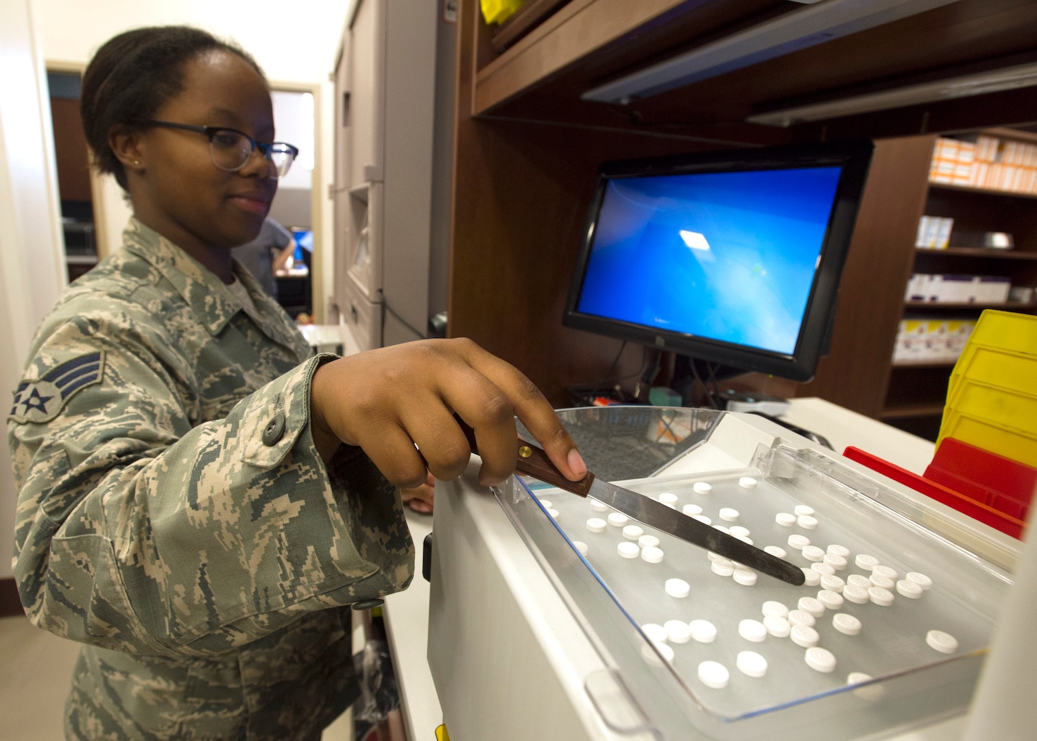 Senior Airman Deja Collins, 59th Medical Training Squadron pharmacy technician, prepares medication for distribution at the satellite pharmacy, Joint Base San Antonio-Lackland June 11. The staff processes 378,000 prescriptions annually.