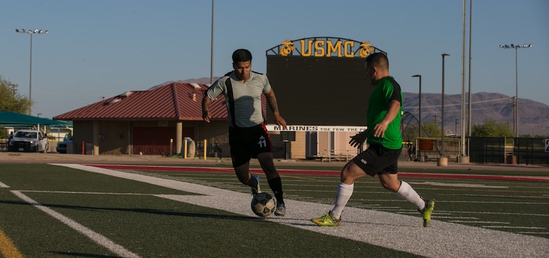 A member of the Marine Corps Communication-Electronics School’s intramural soccer team takes the ball up the field during the installation’s intramural soccer finals at Felix Field aboard the Marine Corps Air Ground Combat Center, Twentynine Palms, Calif., June 7, 2018. The MCCES team won 3-0, defeating the Headquarters’ Battalion team. (U.S. Marine Corps photo by Lance Cpl. Dave Flores)