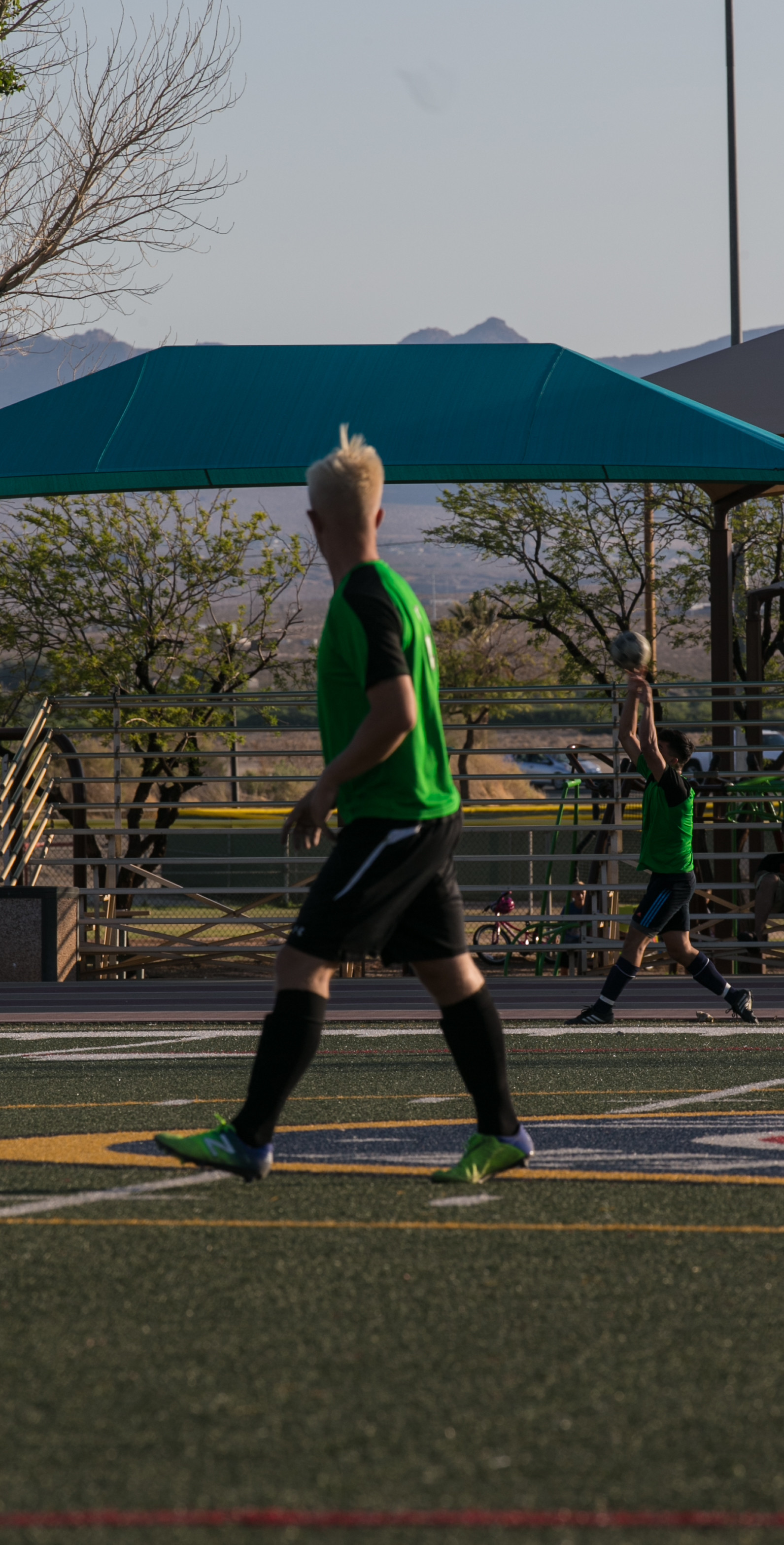 A member of the Headquarters Battalion’s intramural soccer team throws the ball inbounds during the installation’s intramural soccer finals at Felix Field aboard the Marine Corps Air Ground Combat Center, Twentynine Palms, Calif., June 7, 2018. The Marine Corps Communication-Electronics School team won 3-0, defeating the Headquarters’ Battalion team. (U.S. Marine Corps photo by Lance Cpl. Dave Flores)