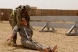 Spc. Dayanna Sanchez, Radiology specialist, 10th Combat Support Hospital, drags a simulated casualty at a physical challenge during the 2016 U.S. Army Central Command Best Warrior Noncommissioned Officer and Soldier of the Year Competition, 19-21 June, at Camp Buehring, Kuwait. Fourteen Soldiers faced off in temperatures nearing 120 degrees competing in multiple events designed to test the Soldiers mental and physical capabilities while focusing on warrior tasks. The events included: a six-mile ruck march, Army physical fitness test, rifle qualification, two physical challenge events, a board appearance, written examination, combatives tournament, and a warrior tasks assessment.