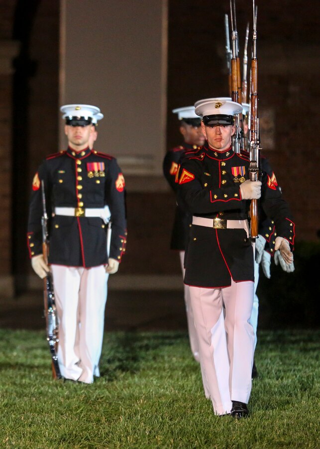 Marines with the U.S. Marine Corps Silent Drill Platoon execute precision rifle drill movements during a Friday Evening Parade at Marine Barracks Washington D.C., June 15, 2018. The guest of honor for the parade was Under Secretary of Defense for Personnel and Readiness, the Honorable Robert Wilkie, and was hosted by Military Under Secretary of Defense for Personnel and Readiness, Lt. Gen. H. Stacy Clardy. (Official U.S. Marine Corps photo by Cpl. Damon Mclean/Released)