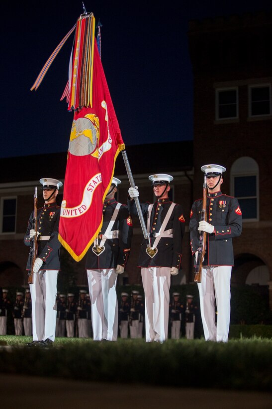 Marines with the U.S. Marine Corps Color Guard present the National Ensign while the National Anthem is played during a Friday Evening Parade at Marine Barracks Washington D.C., June 15, 2018.