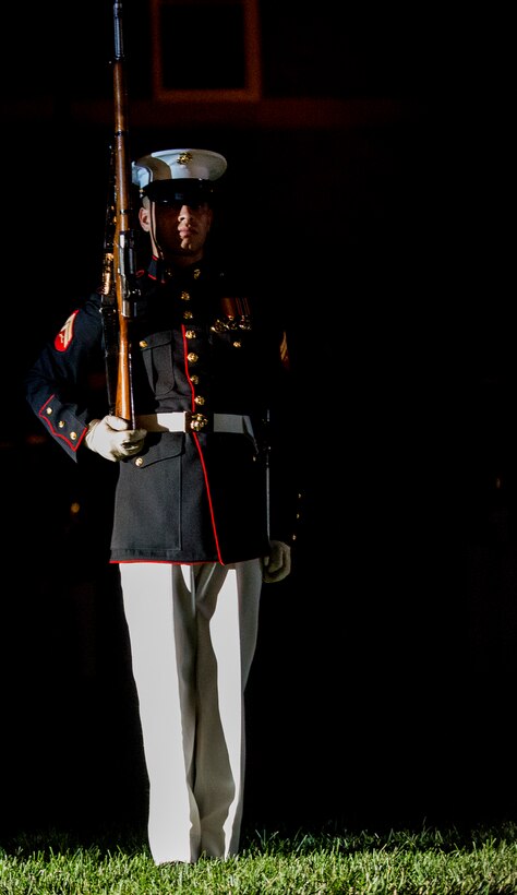 Corporal Joshua Newton, rifle inspection team, U.S. Marine Corps Silent Drill Platoon, stands at “steep right” during a Friday Evening Parade at Marine Barracks Washington D.C., June 15, 2018.