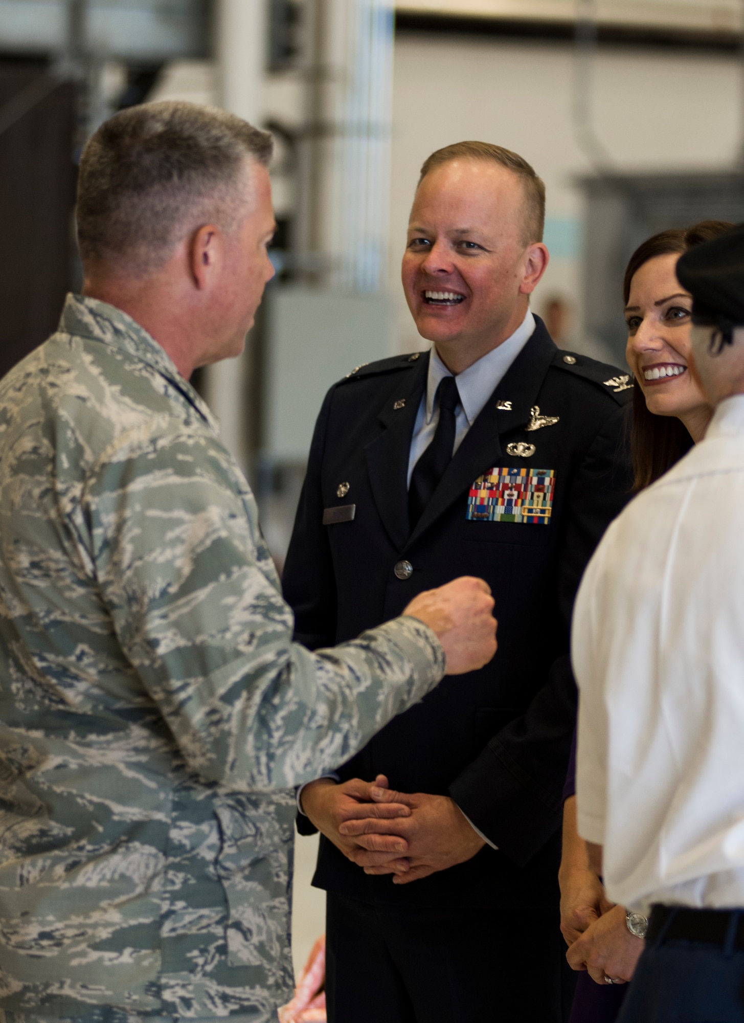 Col. Derek Salmi, 92nd Air Refueling Wing commander, and his wife speak with Brig. Gen. Jeremy Horn, Washington Air National Guard commander, during an assumption of command ceremony June 15, 2018, at Fairchild Air Force Base, Wash. The 92d ARW operates 35 KC-135 R/T Stratotanker aircraft manned by 58 aircrews to support worldwide military missions. (U.S. Air Force photo/ Senior Airman Sean Campbell)