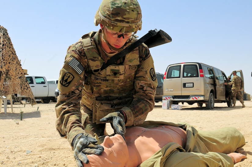 Spc. Drummond Smithson, an air defense battle management system operator with Company A, 5th Battalion, 5th Air Defense Artillery Regiment, assesses the wounds of a first aid dummy during the 3rd Army Best Warrior Soldier and NCO of the Year Competition June 2. Seven Soldiers vied for the top spot over four days of challenges, including an Army Physical Fitness Test, a 12-mile foot march, various physical challenges, a combatives tournament, Warrior Tasks and Drills, and a comprehensive board covering basic Soldier knowledge.