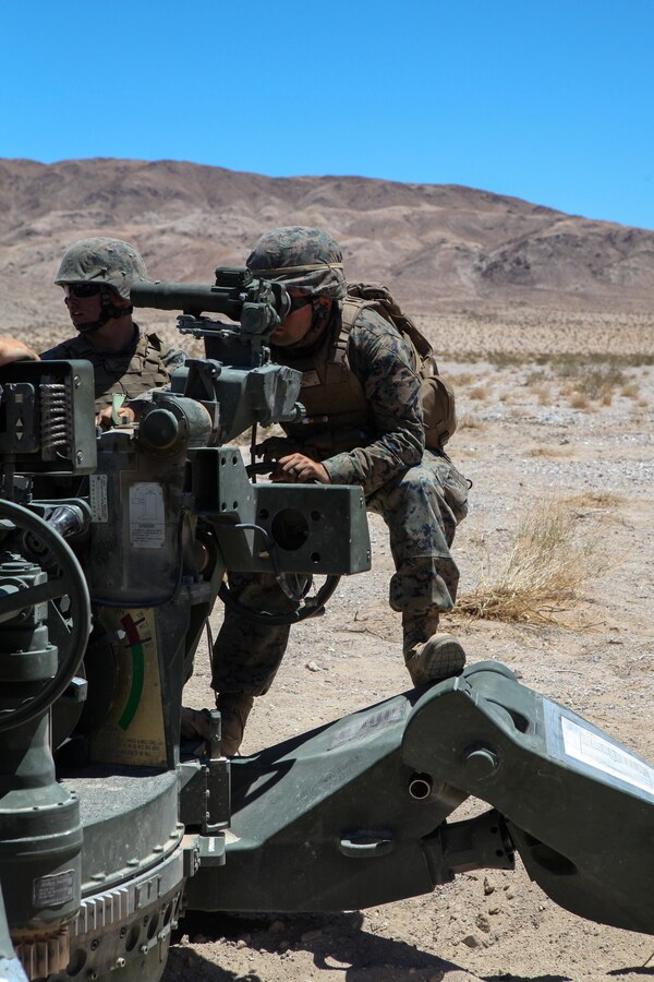 Corporal Jonathan W. Corwin, a Field Artillery Cannoneer, with Mike Battery, 3rd Battalion, 14th Marine Regiment, 4th Marine Division, commands the Howitzer during a direct fire shoot at Integrated Training Exercise 4-18 in Twentynine Palms, California, June 13, 2018. ITX 4-18 is a live-fire and maneuver combined arms exercise designed to train battalion and squadron-sized units in tactics, techniques, and procedures required to provide a sustainable and ready operational reserve for employment across the full spectrum of crisis and global engagement.