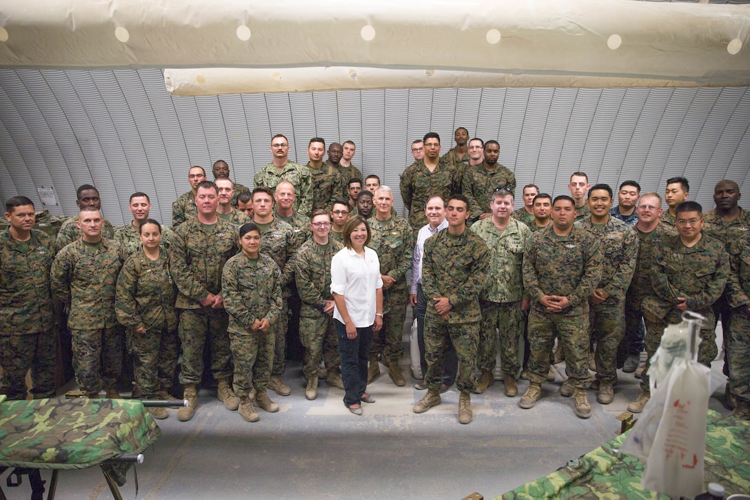 Distinguished visitors pose for a photograph with the sailors running the Regimental Aid Station on Camp Wilson during Integrated Training Exercise 4-18 at Marine Corps Air Ground Combat Center Twentynine Palms, Calif., June 13, 2018.
