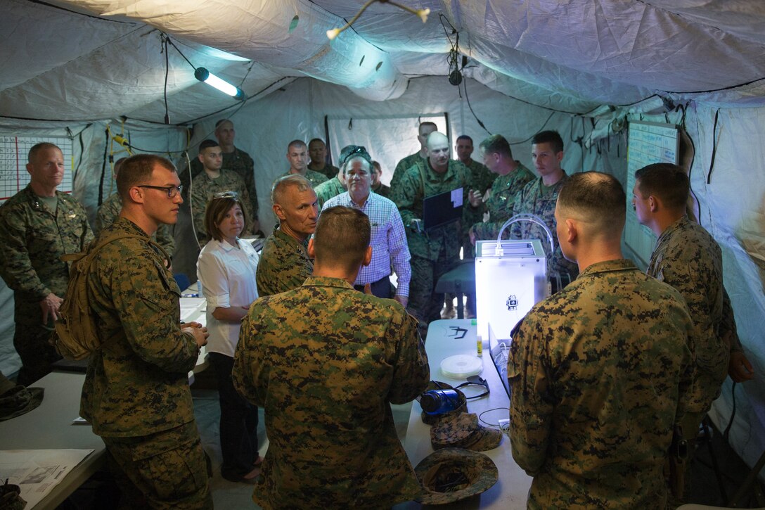 Capt. Christopher Dippel, Inspector Instructor at Maintenance Service Company, Combat Logistics Battalion 25, Combat Logistics Regiment 45, 4th Marine Logistics Group, demonstrates, to distinguished visitors, the capabilities of their Ultimaker 3D printer, during Integrated Training Exercise 4-18 at Marine Corps Air Ground Combat Center Twentynine Palms, Calif., June 13, 2018.