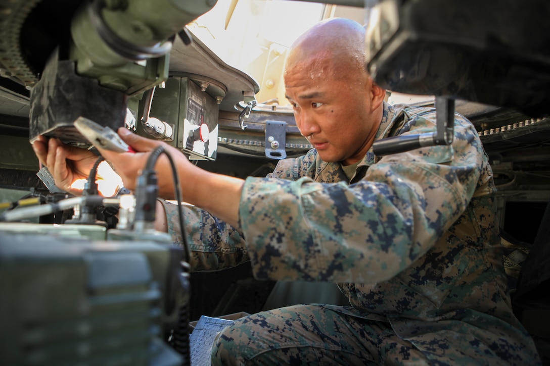 Cpl. Jin W. Kang, a motor transportation operator with Headquarters Company, 23rd Marine Regiment, 4th Marine Division, in San Bruno, California, conducts vehicle maintenance during Integrated Training Exercise 4-18 at Marine Corps Air Ground Combat Center Twentynine Palms, California, on June 17, 2018. ITX is a service level training events which aims to prepare units for combat under the most realistic conditions possible. (U.S. Marine Corps photo by Cpl. Alexis B. Rocha/released)