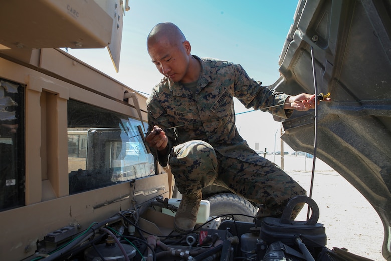 Cpl. Jin W. Kang, a motor transportation operator with Headquarters Company, 23rd Marine Regiment, 4th Marine Division, in San Bruno, California, conducts vehicle maintenance during Integrated Training Exercise 4-18 at Marine Corps Air Ground Combat Center Twentynine Palms, California, on June 17, 2018. ITX is a service level training events which aims to prepare units for combat under the most realistic conditions possible. (U.S. Marine Corps photo by Cpl. Alexis B. Rocha/released)