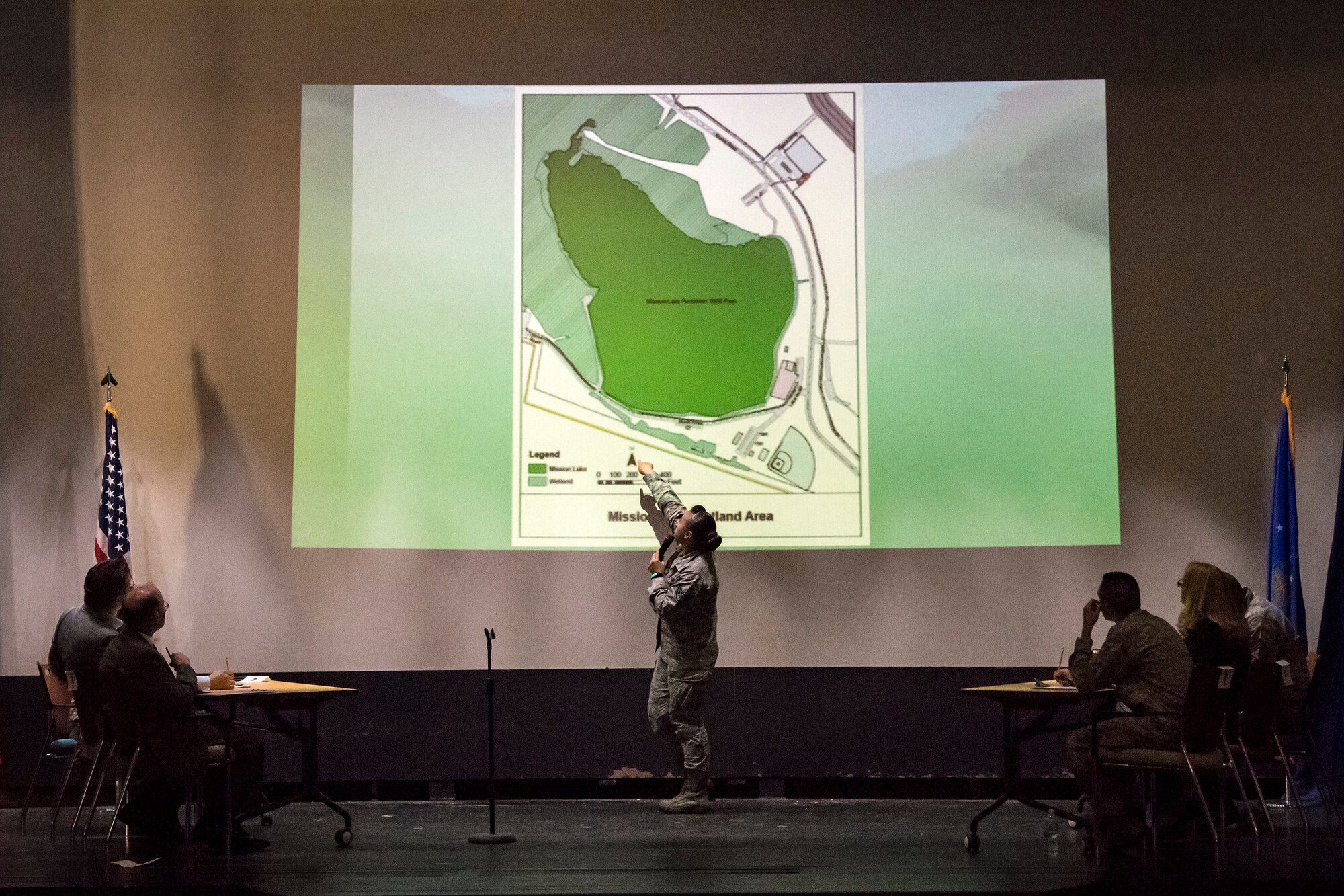 Staff Sgt. Samantha Hampton, center, 23d Mission Support Group command staff administrator, gives a presentation during Spark Tank, June 15, 2018, at Moody Air Force Base, Ga. Spark Tank, a spinoff of the show Shark Tank, gave Airmen the opportunity to propose projects and improvements for Moody to leaders from the 23d WG and the local community. (U.S. Air Force photo by Airman 1st Class Eugene Oliver)