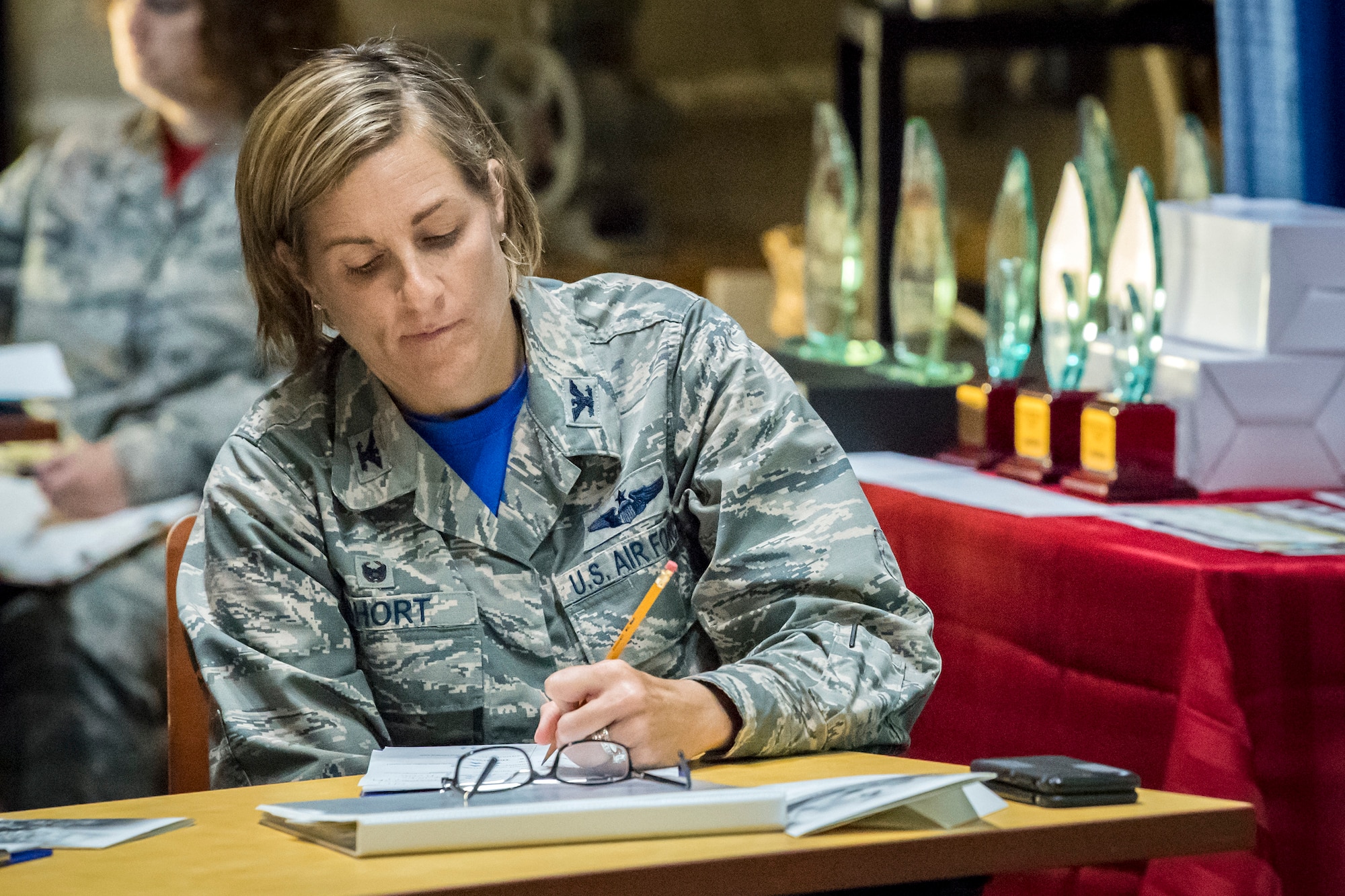 Col. Jennifer Short, 23d Wing (WG) commander, writes down notes during a Spark Tank presentation, June 15, 2018, at Moody Air Force Base, Ga. Spark Tank, a spinoff of the show Shark Tank, gave Airmen the opportunity to propose projects and improvements for Moody to leaders from the 23d WG and the local community. (U.S. Air Force photo by Airman 1st Class Eugene Oliver)