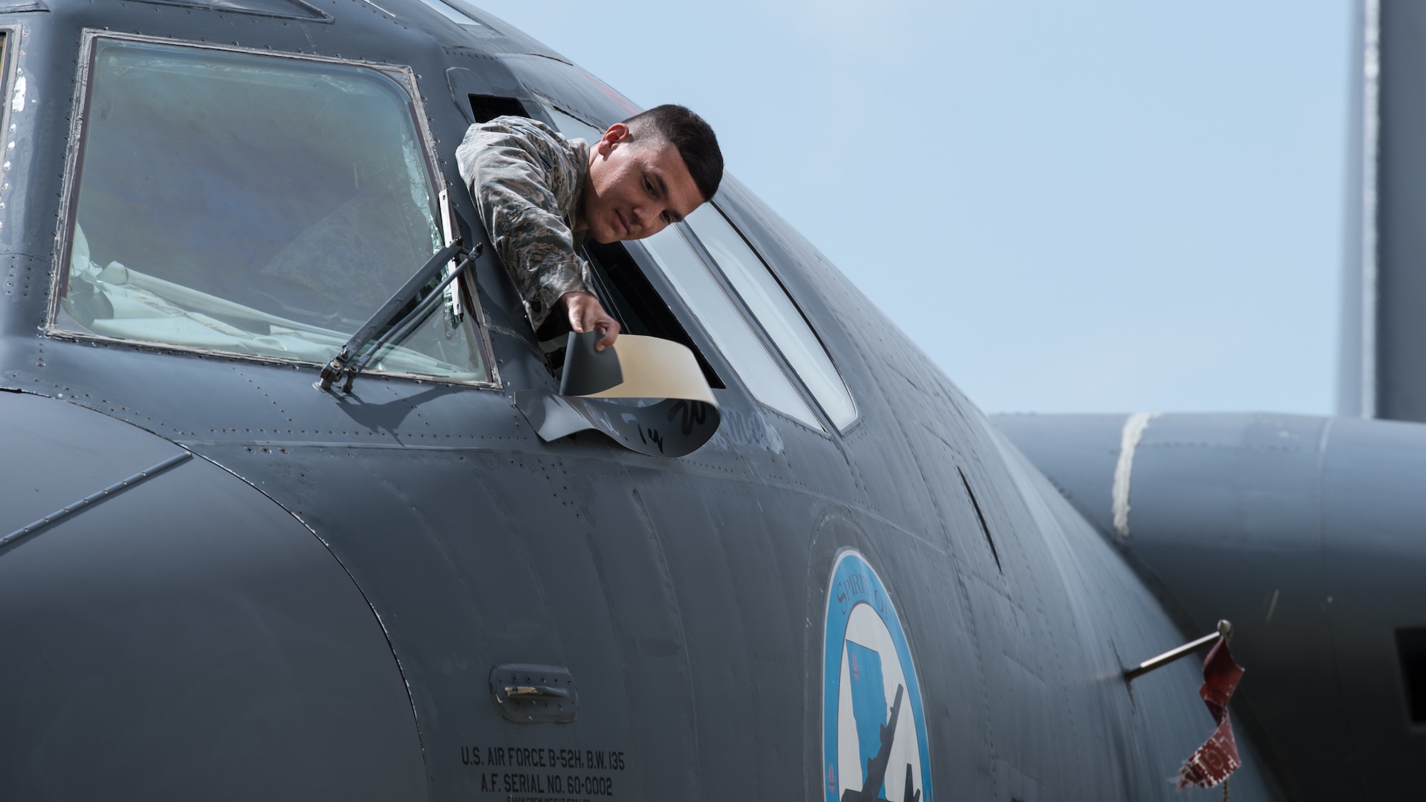 An Airman reveals the new commander’s name on a B-52 Stratofortress during the 2nd Bomb Wing change of command ceremony at Barksdale Air Force Base, La. June 18, 2018. Traditionally, commanders have their names painted onto the wing’s flagship. (U.S. Air Force photo by Airman 1st Class Lillian Combes)