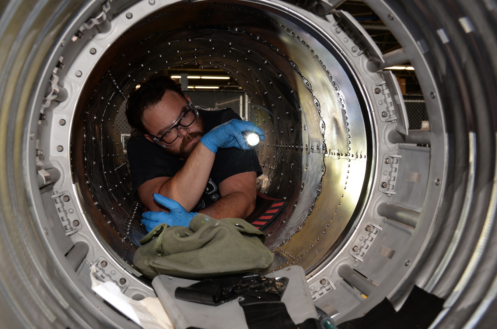 Jason Moore, 575th Aircraft Maintenance Squadron maintenance support flight, inspects the inside of T-38 Talon boat tail section April 17, 2018, at Joint Base San Antonio-Randolph, Texas. (U.S. Air Force photo by Alex R. Lloyd)