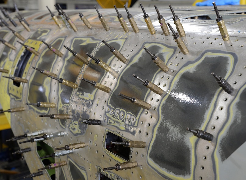 Hundreds of clecos are used to maintain alignment and structural strength after the normal screws have been removed. (U.S. Air Force photo by Alex R. Lloyd)