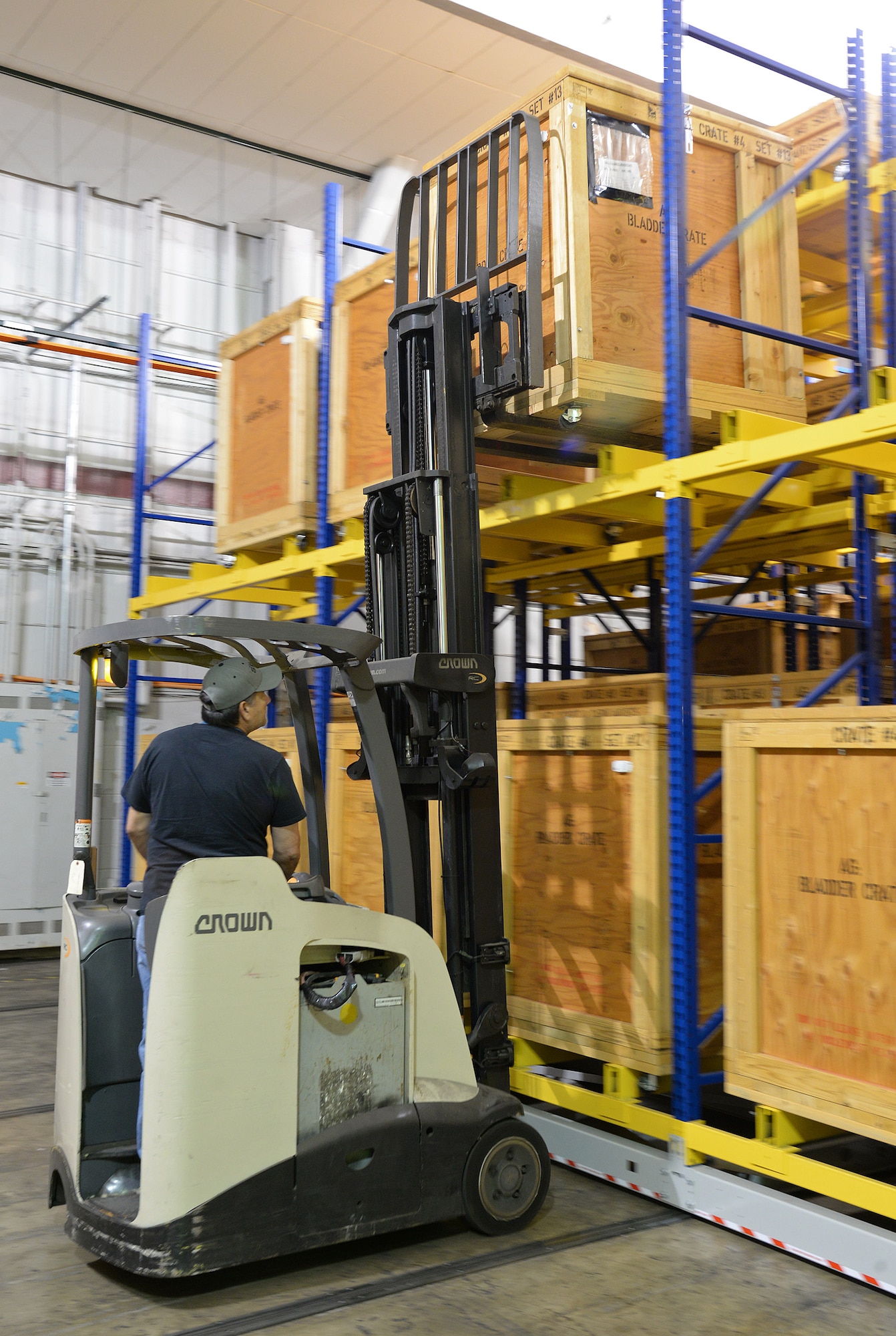 Gilbert De La O uses a forklift April 19, 2018, at Joint Base San Antonio-Randolph, Texas, to retrieve a crate of parts needed on the Pacer Classic III production line. (U.S. Air Force photo by Alex R. Lloyd)