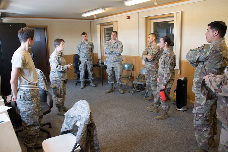 Airmen from the 621st Air Mobility Operations Squadron (AMOS) from Joint Base McGuire-Dix-Lakehurst in New Jersey, and the 321st AMOS from Travis Air Force Base in California, meet with members of the 439th Contingency Response Flight from Westover Air Reserve Base, Massachussets, and the 439th Contingency Response Group from Ramstein Air Base, RP, Germany, during Exercise Swift Response 18 at Ramstein Air Base, RP, Germany on June 4, 2018. (U.S. Air Force photo by Tech Sgt. Robert Waggoner/RELEASED)