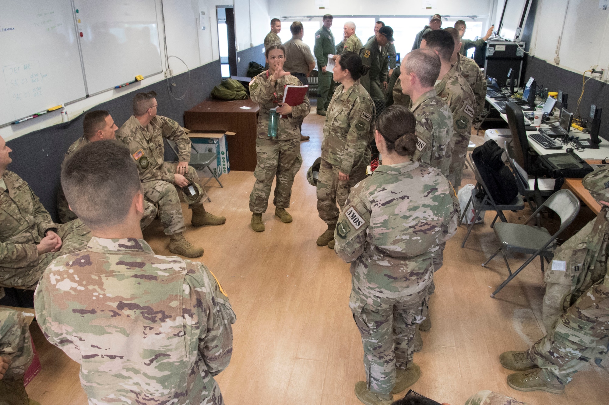 Airmen from the 621st Air Mobility Operations Squadron (AMOS) from Joint Base McGuire-Dix-Lakehurst in New Jersey, and the 321st AMOS from Travis Air Force Base in California, meet with members of the 439th Contingency Response Flight from Westover Air Reserve Base, Massachussets, and the 439th Contingency Response Group from Ramstein Air Base, RP, Germany, during Exercise Swift Response 18 at Ramstein Air Base, RP, Germany on June 4, 2018. (U.S. Air Force photo by Tech Sgt. Robert Waggoner/RELEASED)