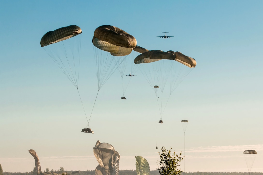 Soldiers conduct a heavy drop airborne operation.