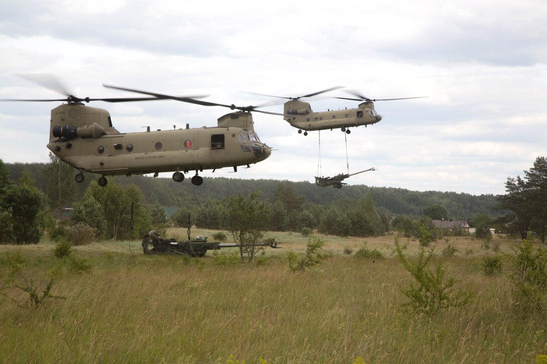 CH-47 Chinook helicopters drop off M777A2 155mm howitzers.