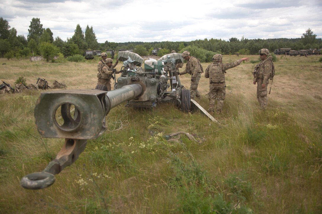 Soldiers prepare to tow their M777A2 155mm howitzers after conducting sling-load operation.