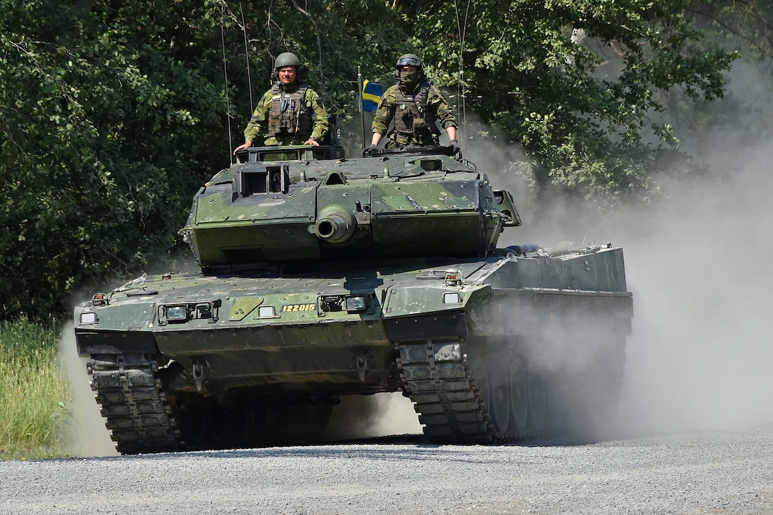 Swedish soldiers maneuver their Stridsvagn 122 main battle tank.
