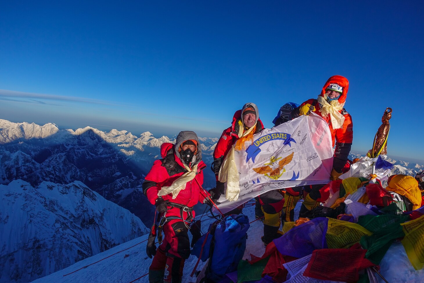 Matt Moniz, Mike Moniz, and guide pose for a photo on the summit of Mount Everest
with a U.S. 7th Fleet flag.  Photo courtesy of the Moniz family.