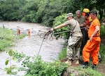 NHARNG 1st Lt. Katrina Simpson, an infantry officer with Mountain Company, works with Salvadoran soldiers and firefighters to complete a rope system spanning the Lempa River in El Salvador June 7, 2018. The swift water rescue training, led by Maj. Brian Fernandes, deputy commander, 12th Civil Support Team, brought N.H. Guardsmen, Salvadoran soldiers and firefighters together to focus on sharing ideas and best practices for rescue techniques to improve interoperability between civilian and military personnel.