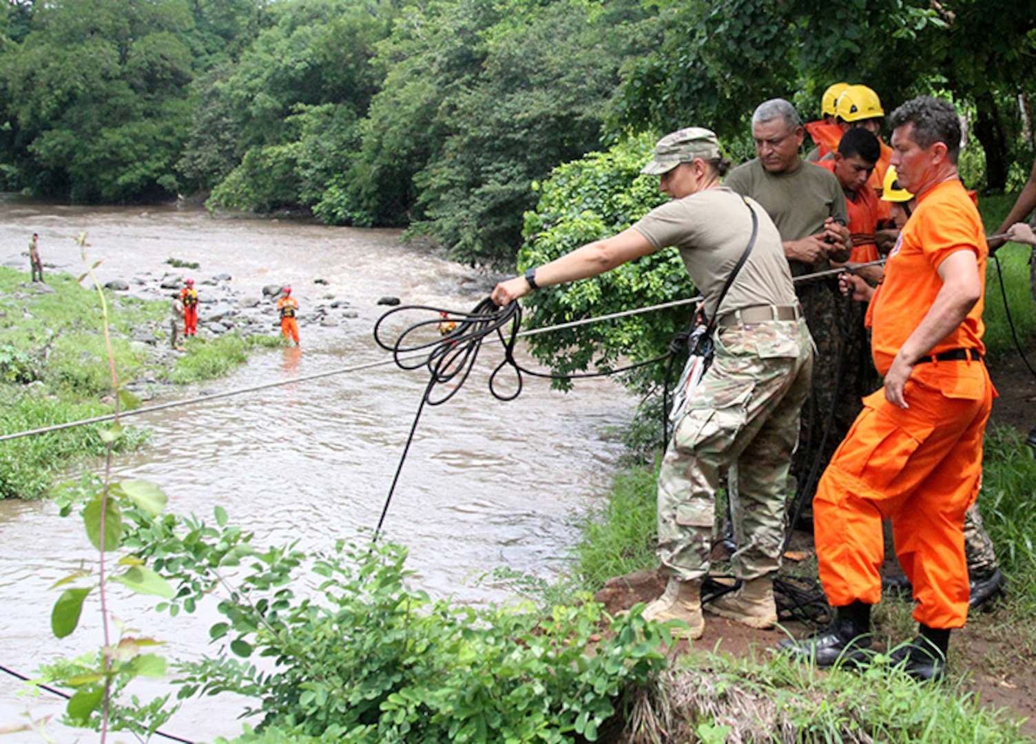 NHARNG 1st Lt. Katrina Simpson, an infantry officer with Mountain Company, works with Salvadoran soldiers and firefighters to complete a rope system spanning the Lempa River in El Salvador June 7, 2018. The swift water rescue training, led by Maj. Brian Fernandes, deputy commander, 12th Civil Support Team, brought N.H. Guardsmen, Salvadoran soldiers and firefighters together to focus on sharing ideas and best practices for rescue techniques to improve interoperability between civilian and military personnel.