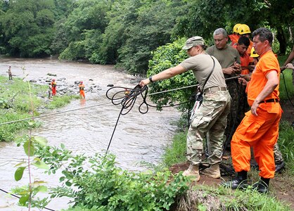 NHARNG 1st Lt. Katrina Simpson, an infantry officer with Mountain Company, works with Salvadoran soldiers and firefighters to complete a rope system spanning the Lempa River in El Salvador June 7, 2018. The swift water rescue training, led by Maj. Brian Fernandes, deputy commander, 12th Civil Support Team, brought N.H. Guardsmen, Salvadoran soldiers and firefighters together to focus on sharing ideas and best practices for rescue techniques to improve interoperability between civilian and military personnel.