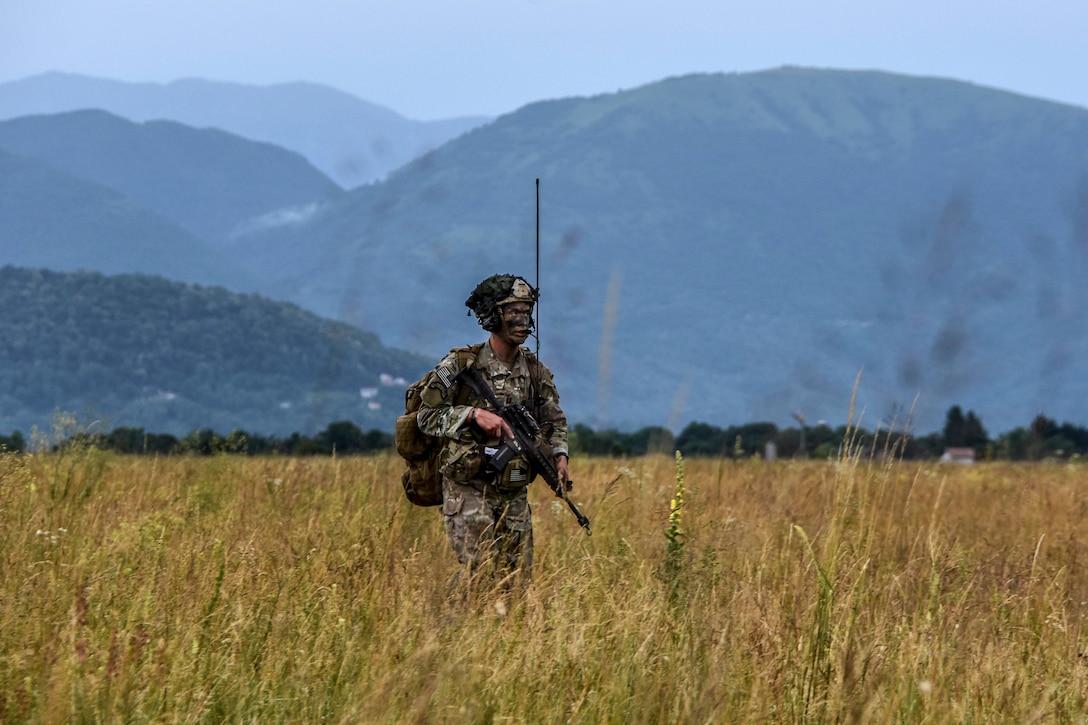 A soldier moves to the designated rally point after conducting airborne operation.