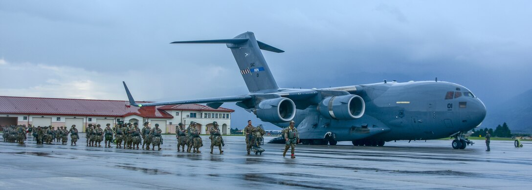 Soldiers prepare to board a C-17 Globemaster IIII aircraft.