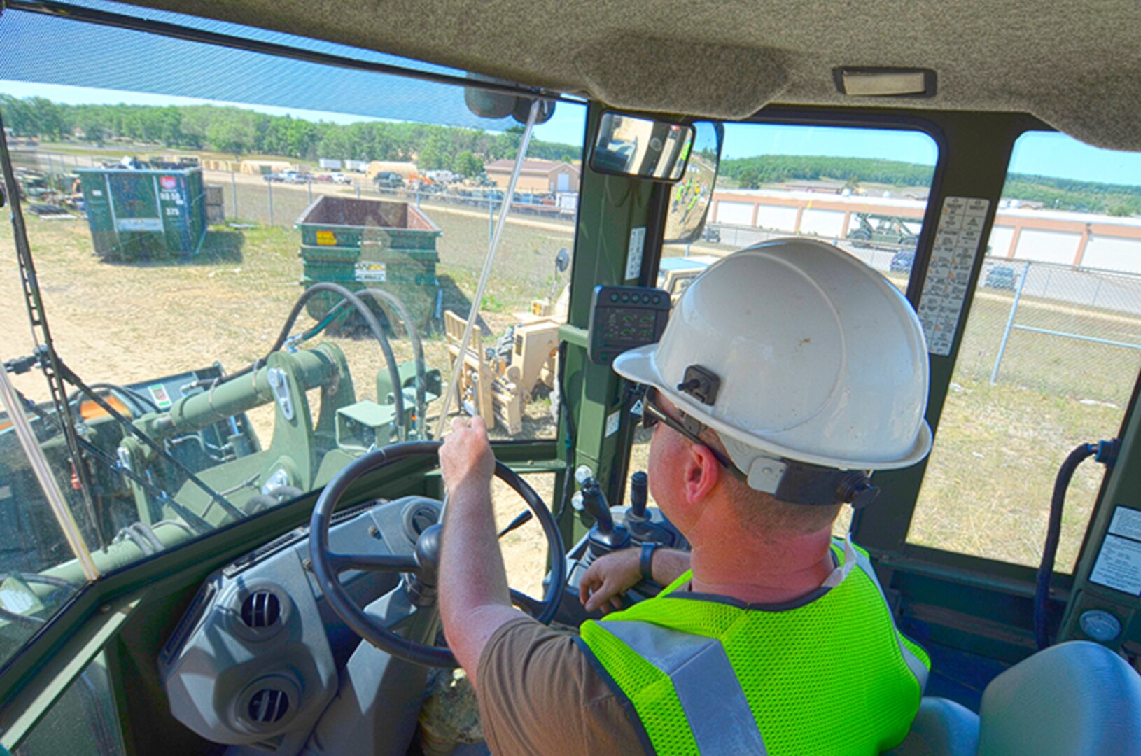 Navy Logistics Specialist 1st Class David Freeman, a member of Disposal Support Unit 2 out of Anniston, Alabama, prepares to drop a load of electronics into an industrial shredder at Camp Grayling, Michigan, during OCORT ’18.