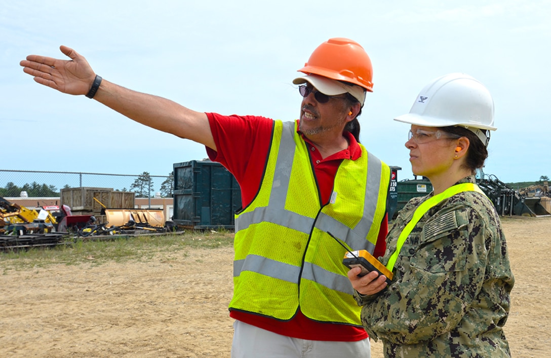 Materials Examiner and Identifier Mike Hoskinson, from the DLA Disposition Services site in Kaiserslautern, Germany, instructs Joint Team Lead, U.S. Navy Capt. Katherine Boyce, on industrial shredder operation during OCORT ’18 at Camp Grayling, Michigan in June.