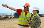 Materials Examiner and Identifier Mike Hoskinson, from the DLA Disposition Services site in Kaiserslautern, Germany, instructs Joint Team Lead, U.S. Navy Capt. Katherine Boyce, on industrial shredder operation during OCORT ’18 at Camp Grayling, Michigan in June.