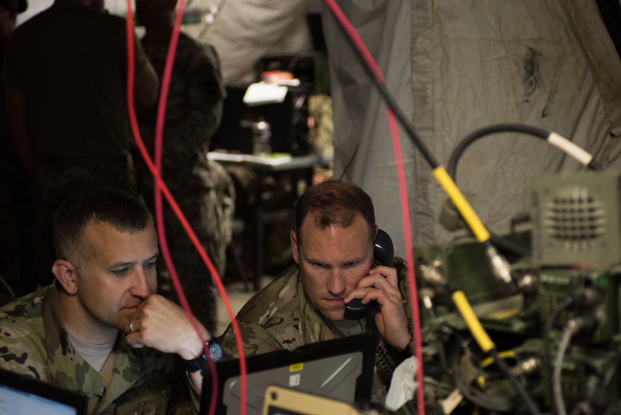 Master Sgt. Benjamin Lake, 146th Air Support Operations Squadron (146th ASOS) chief of weapons and tactics, coordinates a simulated air strike during a combat scenario with Lt. Col. Craig Ilschner, commander of the 146th ASOS, during Warfighter 18-5 (WFX-18-5) June 10, 2018, at Camp Atterbury Joint Maneuver Training Center near Edinburgh, Indiana. WFX-18-5 was conducted to help components of the 34th Infantry Division become accustomed to using Army battle drills in a computer-simulated combat environment. (U.S. Air National Guard photo by Staff Sgt. Brigette Waltermire)