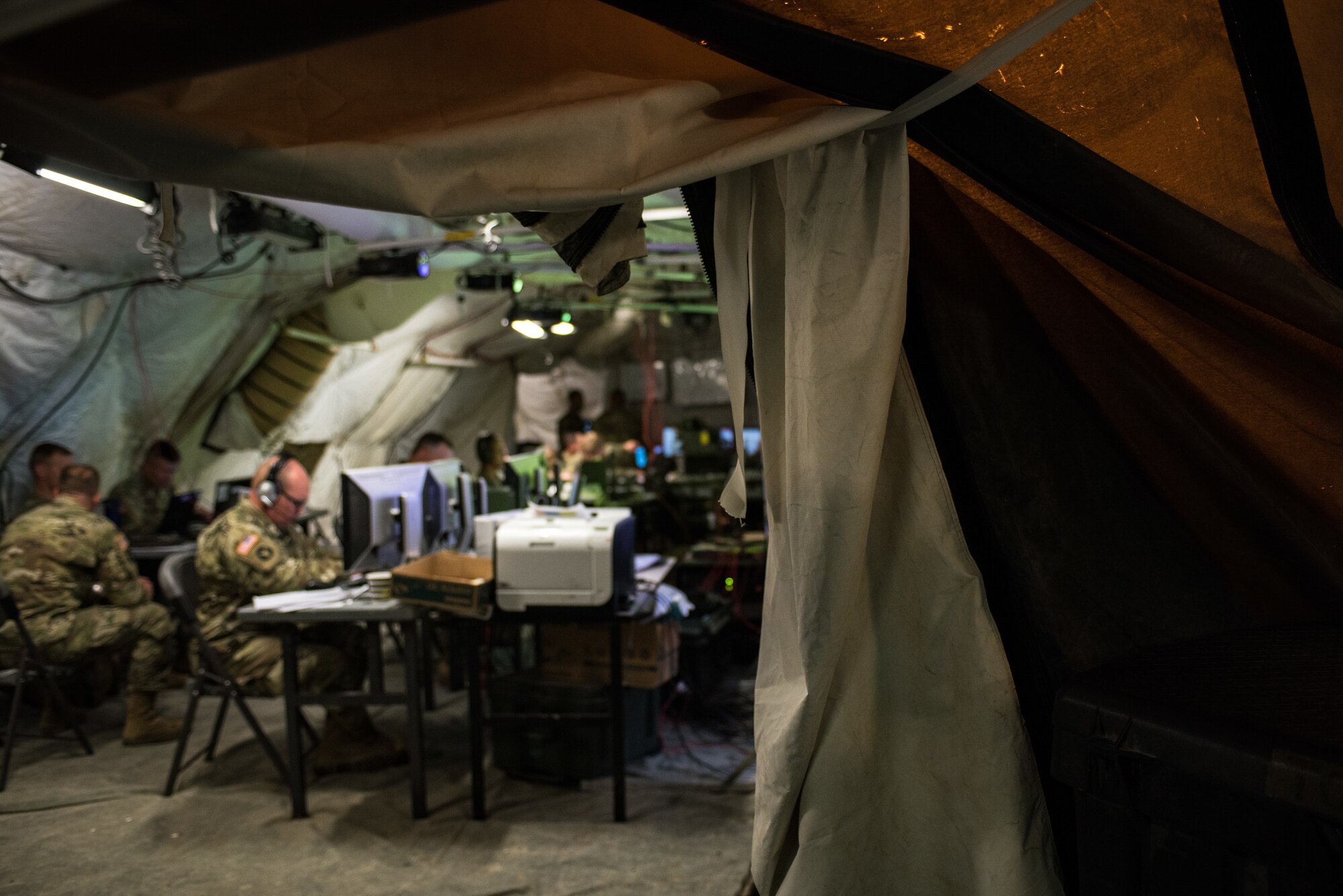 Soldiers with the Minnesota Army National Guard 1st Armored Brigade Combat Team, 34th Infantry Division, use a mobile tactical operations center to conduct combat simulations as a response cell during Warfighter 18-5 (WFX 18-5) June 11, 2018, at Camp Atterbury Joint Maneuver Training Center near Edinburgh, Indiana. WFX 18-5 was conducted to help components under the 34th Infantry Division become accustomed to using Army battle drills in a computer-simulated combat environment. (U.S. Air National Guard photo by Staff Sgt. Brigette Waltermire)