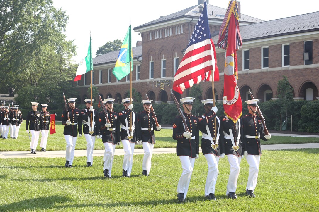 Marines with the U.S. Marine Corps Color Guard march across the parade deck during a Troop Review Ceremony at Marine Barracks Washington D.C., June 18, 2018. The Barracks hosted our Brazilian and Mexican military counterparts to honor Commandant of the Brazil Corps of Naval Infantry, Adm. Alexandre Jose Bareto de Mattos, and Coordinator General, Mexico Naval Infantry, Vice Adm. Rafael Lopez Martinez.