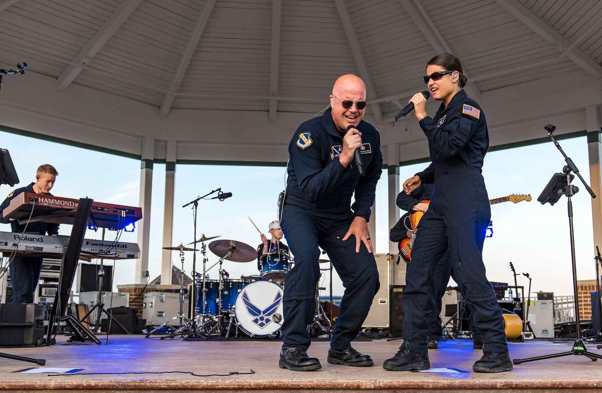 Senior Master Sgt. Ryan Carson, Max Impact superintendent and vocalist, and Tech. Sgt. Nalani Quintello, Max Impact vocalist, perform a song together June 16, 2018, on the bandstand at Rehoboth Beach, Del. Max Impact, the premier rock band of the U.S. Air Force, is stationed at Joint Base Anacostia-Bolling in Washington, D.C. (U.S. Air Force photo by Roland Balik)