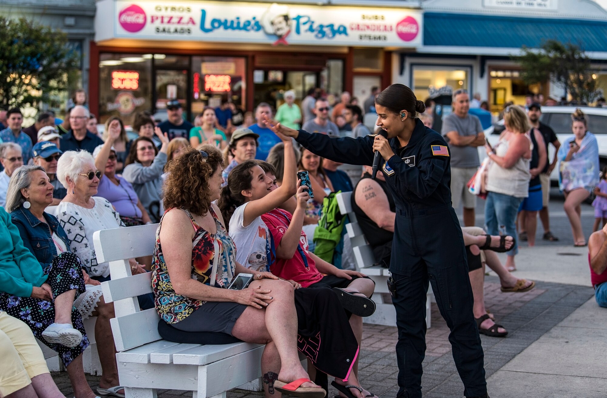 Tech. Sgt. Nalani Quintello, Max Impact vocalist, gives a high five to Gwennyth Farmer of Millsboro, Del., during the band’s performance June 16, 2018, on the bandstand at Rehoboth Beach, Del. Max Impact performed 20 songs for hundreds of beachgoers during the free, public concert. Max Impact, the premier rock band of the U.S. Air Force, is stationed at Joint Base Anacostia-Bolling in Washington, D.C. (U.S. Air Force photo by Roland Balik)