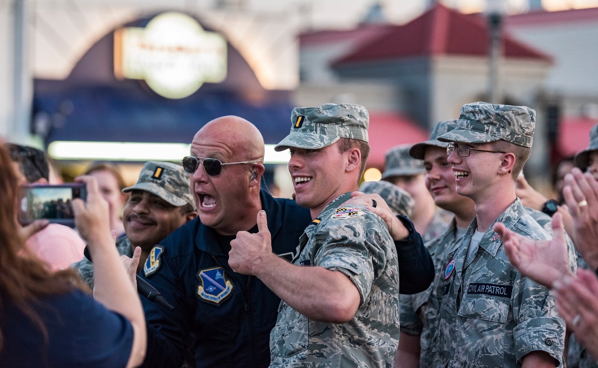 Senior Master Sgt. Ryan Carson, Max Impact superintendent and vocalist, poses for a photo with Civil Air Patrol cadets June 16, 2018, during a concert on the bandstand at Rehoboth Beach, Del. Max Impact, the premier rock band of the U.S. Air Force, is stationed at Joint Base Anacostia-Bolling in Washington, D.C. (U.S. Air Force photo by Roland Balik)