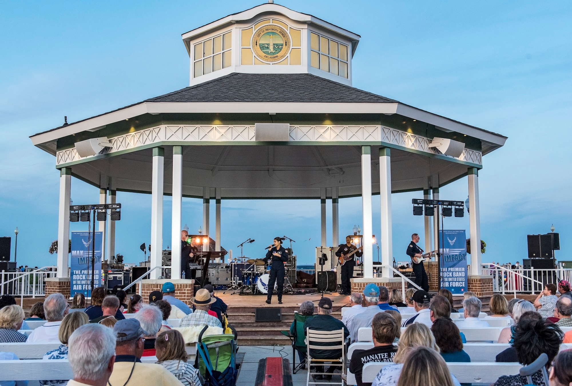 Max Impact, the U.S. Air Force premier rock band stationed at Joint Base Anacostia-Bolling in Washington, D.C., performs June 16, 2018, on the bandstand at Rehoboth Beach, Del. Hundreds of beachgoers watched the band’s 75-minute performance featuring 20 songs. (U.S. Air Force photo by Roland Balik)