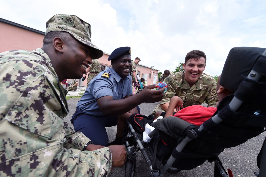 Troops interact with a child in the Bahamas.