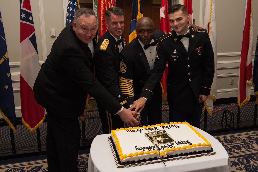 From left, Thomas Greco, U.S. Army Training and Doctrine Command deputy chief of staff; U.S. Army Maj. Gen. Malcom B. Frost, Center for Initial Military Training commanding general; Command Sgt. Maj. Edward W. Mitchell, CIMT command sergeant major; and Pvt. Nicholas Jackson, McDonald Army Health Center medic, cut the cake during the Army Birthday Ball at the Colonial Williamsburg Lodge, in Williamsburg, Virginia, June 16, 2018.