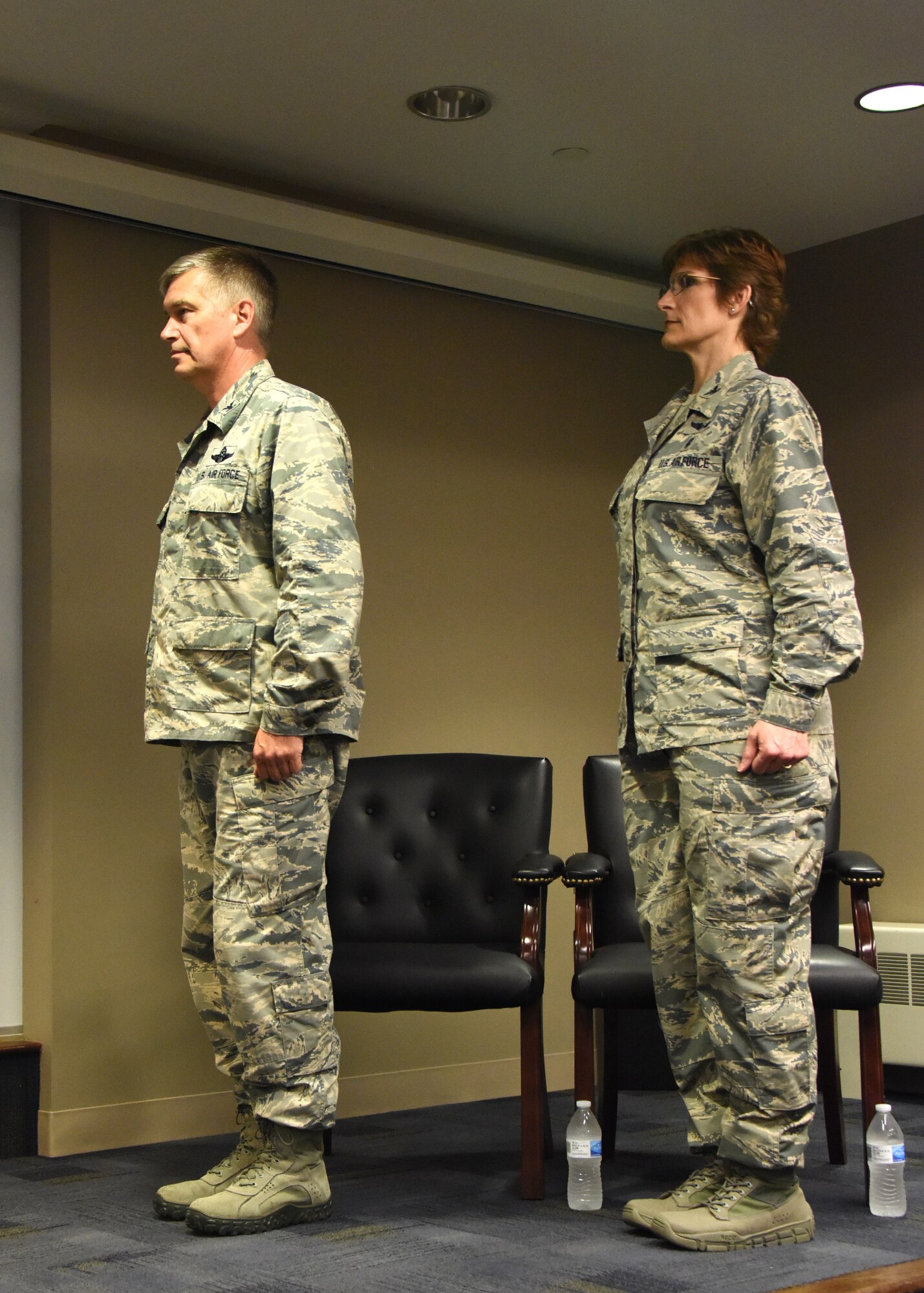 Col. Douglas Strawbridge, commander of the 911th Airlift Wing, and Col. Karen Steiner, commander of the 911th Aeromedical Staging Squadron, stand at attention to start the assumption of command ceremony at the Pittsburgh International Airport Air Reserve Station, Pennsylvania, June 2, 2018. The ceremony is a military tradition that represents the passing of authority of a command from one officer to another and has great symbolism attached to the change of command. (U.S. Air Force Photo by Senior Airman Grace Thomson)