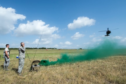 Colonel Kjäll Gopaul, mission pathfinder, communicates on the radio with Soldiers of Texas Army National Guard Company C, 2-149 Aviation, prior to a sling load mission as part of OPERATION Lone Star Vigilance June 10, 2018, at Joint Base San Antonio-Camp Bullis, Texas. Operation Lone Star Vigilance was a joint-training exercise involving Active-Duty and Reserve Airmen and Soldiers from the Texas Army National Guard from installations across San Antonio. The multi-service missions saw the successful completion of aerial reconnaissance, sling loading of cargo, MEDEVAC hoists, personnel recovery and the simultaneous operation of multiple helicopter landing zones. (U.S. Air Force photo by Senior Airman Stormy Archer)